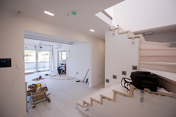 Image showing carpenters installing glass door with a wooden frame