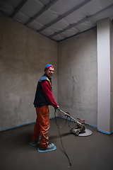 Image showing worker performing and polishing sand and cement screed floor