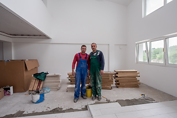 Image showing portrait of Workers and builders with dirty uniform in apartment