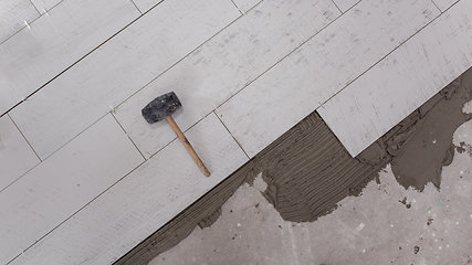 Image showing Ceramic wood effect tiles and tools for tiler on the floor