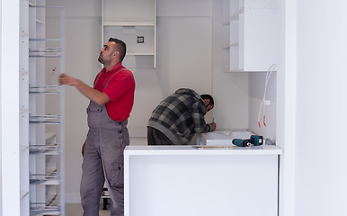 Image showing workers installing a new kitchen