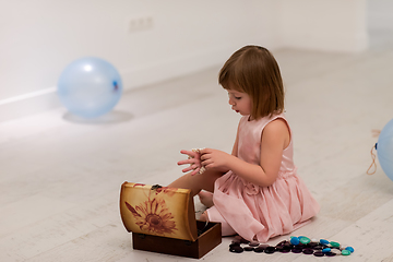 Image showing little girl enjoying while playing with mother\'s jewelry