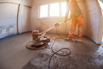 Image showing worker performing and polishing sand and cement screed floor