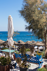 Image showing beach with umbrellas and deck chairs by the sea in Santorini