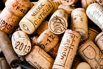 Image showing old cork stoppers of French wines in a wire basket