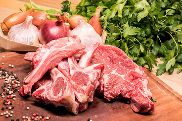 Image showing raw lamb chops on a wooden board for barbecue