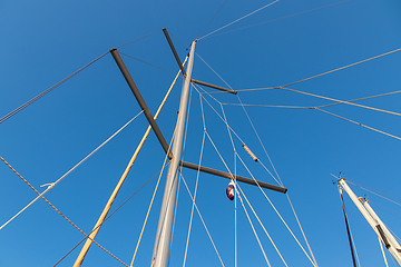 Image showing rigging mast and halyards of a sailing boat under a beautiful bl