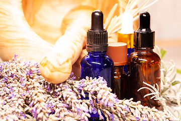 Image showing lavender mortar and pestle and bottles of essential oils for aro