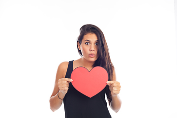 Image showing beautiful happy young woman who is holding a big red heart for v