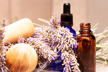 Image showing lavender mortar and pestle and bottles of essential oils for aro