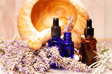 Image showing lavender mortar and pestle and bottles of essential oils for aro