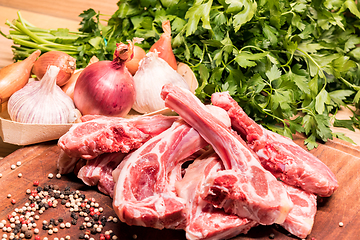 Image showing raw lamb chops on a wooden board for barbecue