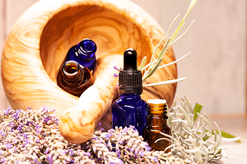 Image showing lavender mortar and pestle and bottles of essential oils for aro