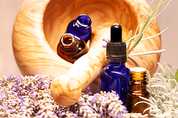 Image showing lavender mortar and pestle and bottles of essential oils for aro