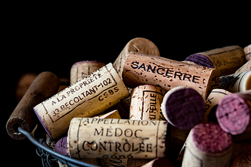 Image showing old cork stoppers of French wines in a wire basket