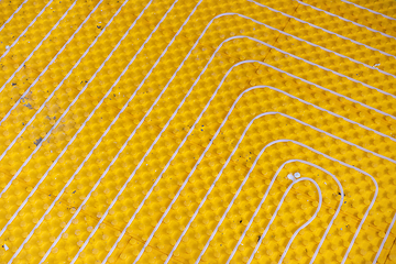 Image showing yellow underfloor heating installation with white pipes