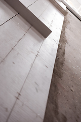 Image showing Ceramic wood effect tiles and tools for tiler on the floor