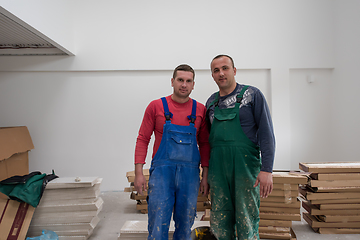 Image showing portrait of Workers and builders with dirty uniform in apartment