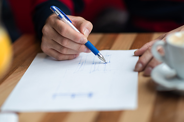 Image showing The hand of the designer with a pen sketching his idea