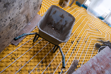 Image showing yellow underfloor heating installation with white pipes