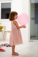 Image showing cute little girl playing with balloons