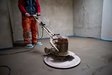 Image showing worker performing and polishing sand and cement screed floor