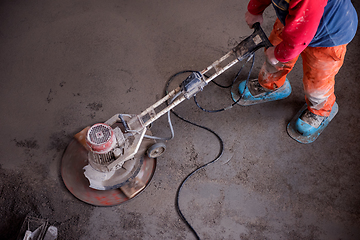 Image showing worker performing and polishing sand and cement screed floor