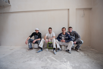 Image showing portrait of Workers and builders with dirty uniform in apartment