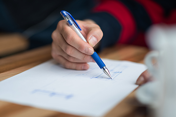 Image showing The hand of the designer with a pen sketching his idea