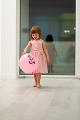 Image showing cute little girl playing with balloons