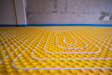 Image showing yellow underfloor heating installation with white pipes