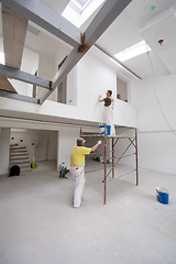 Image showing construction worker using scaffold while plastering