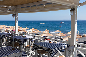 Image showing restaurant terrace in front of the beach in kamari on the island