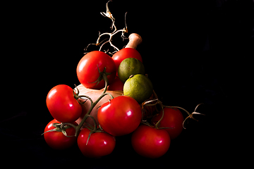 Image showing large red and ripe tomatoes with a mortar and pestle in olive wo