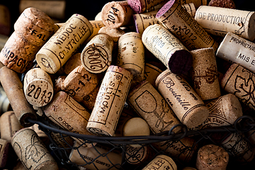 Image showing old cork stoppers of French wines in a wire basket