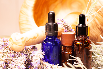 Image showing lavender mortar and pestle and bottles of essential oils for aro