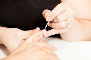 Image showing Laying nail polish on a woman\'s hands