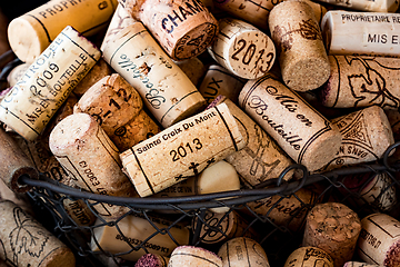 Image showing old cork stoppers of French wines in a wire basket