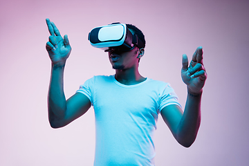 Image showing Young african-american man\'s using VR-glasses in neon light