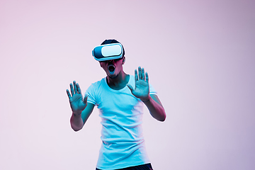 Image showing Young african-american man\'s using VR-glasses in neon light