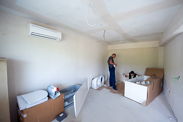 Image showing professional plumber working in a bathroom