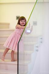 Image showing little girl playing on stairs at home