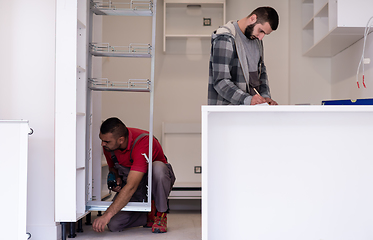 Image showing workers installing a new kitchen