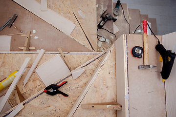 Image showing work in progress on stylish interior with wooden stairs