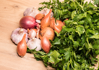 Image showing garlic onion shallot parsley on a wooden board