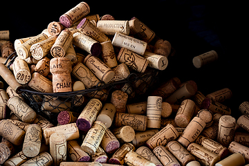 Image showing old cork stoppers of French wines in a wire basket