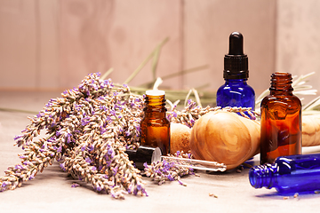 Image showing lavender mortar and pestle and bottles of essential oils for aro