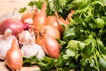 Image showing garlic onion shallot parsley on a wooden board