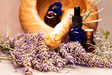 Image showing lavender mortar and pestle and bottles of essential oils for aro