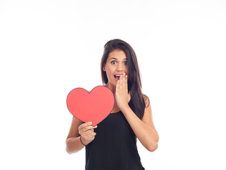 Image showing beautiful happy young woman who is holding a big red heart for v